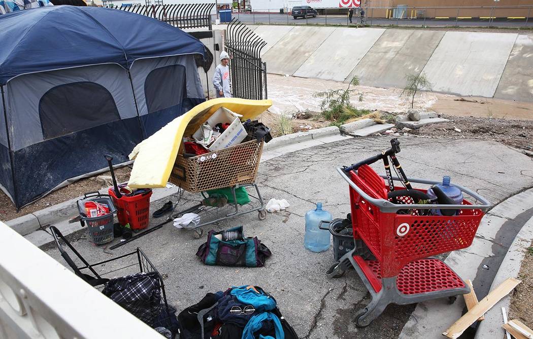A homeless man, who declined to give his name, stands outside his tent near the Flamingo Wash o ...