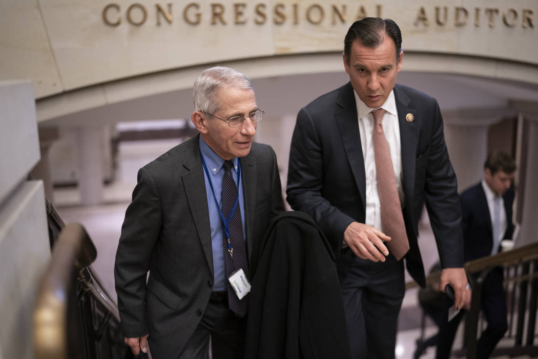 Dr. Anthony Fauci, left, director of the National Institute of Allergy and Infectious Diseases, ...