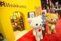 Greg Nuson poises for a photo with Rilakkuma cartoon characters during the Licensing Expo 201 ...