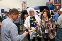 Rita Crompton, of Denver, founder of The Inventor Lady, and Jimi Bush give free samples of the ...
