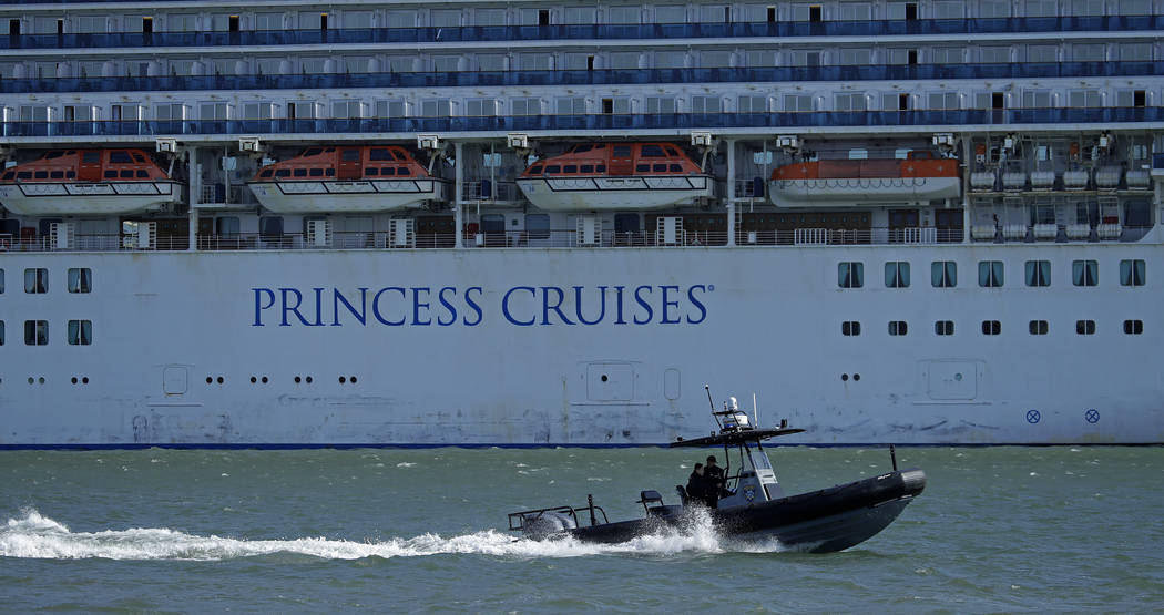 An Oakland Police boat patrols the waters beside the Grand Princess cruise ship, which remains ...
