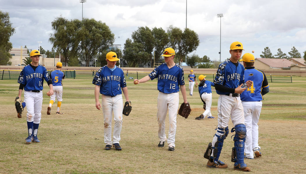 Pahranagat Valley High School players get back to the dugout after warming up during the Spring ...