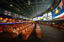 David Gustafson of Jackson, Wyo. watches TV in the normally crowded Westgate sportsbook Friday, ...