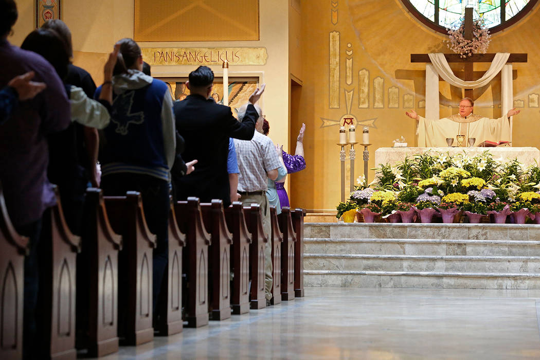 The Rev. Gerald Grupczynski, pastor of Our Lady of Las Vegas Roman Catholic Church, right, hold ...