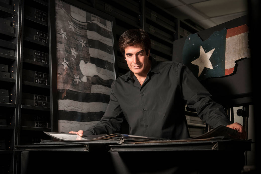 Magic legend David Copperfield is shown with an image of the original Star-Spangled Banner at t ...