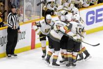 Vegas Golden Knights players celebrate after Max Pacioretty scored the tying goal against the N ...