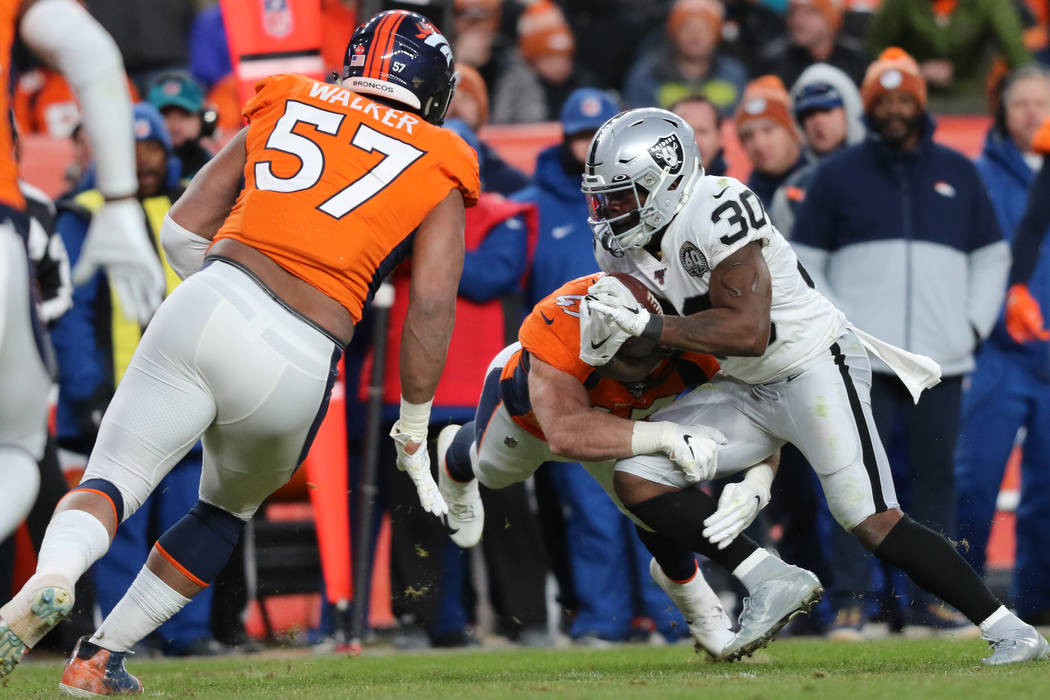 Oakland Raiders running back Jalen Richard (30) carries the ball against the Denver Broncos and ...