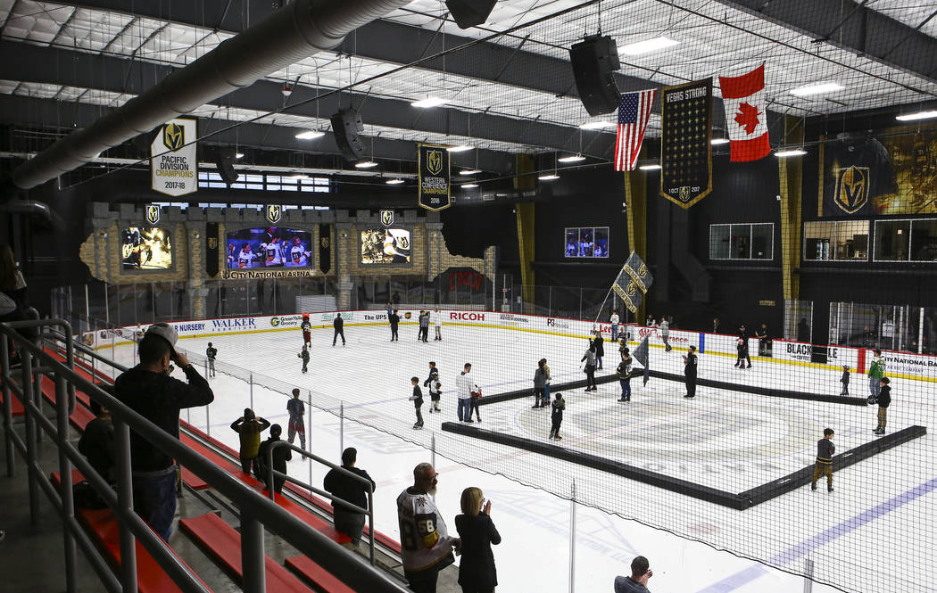 Golden Knights fans skate on the ice at City National Arena during a watch party for an away ga ...