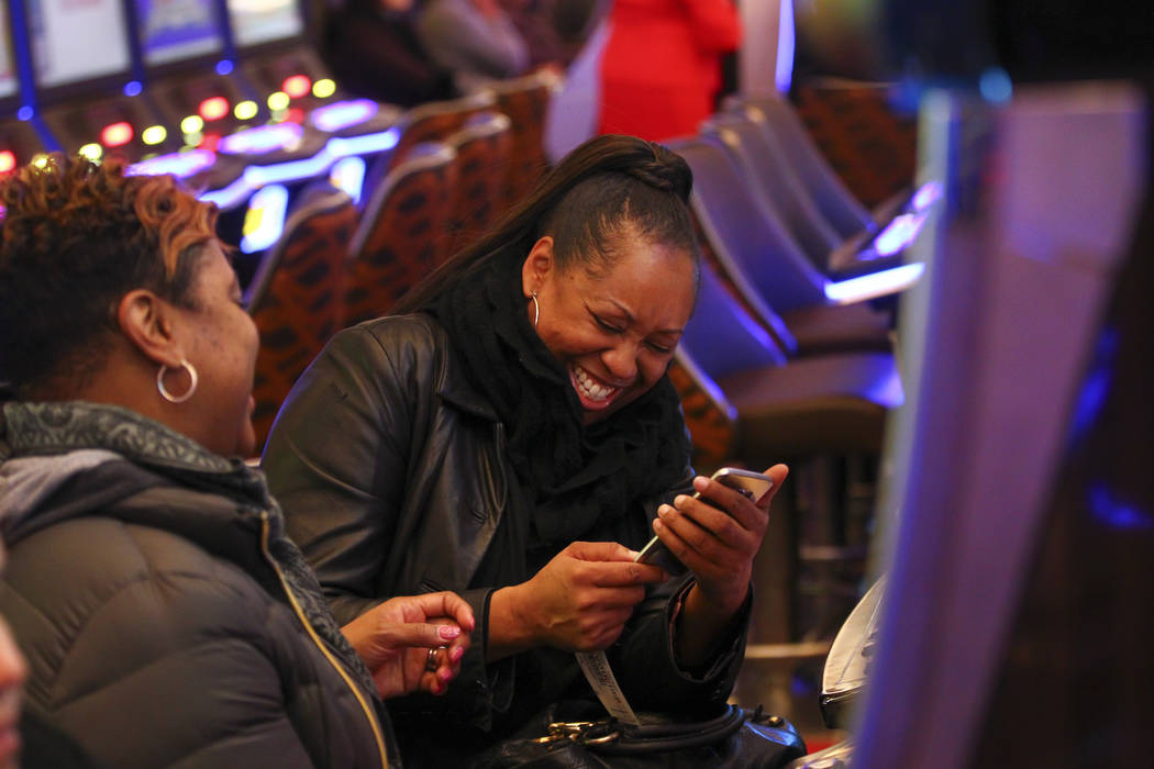 Prince George's County resident Katina Morris reacts after taking a photo of her winnings vouch ...