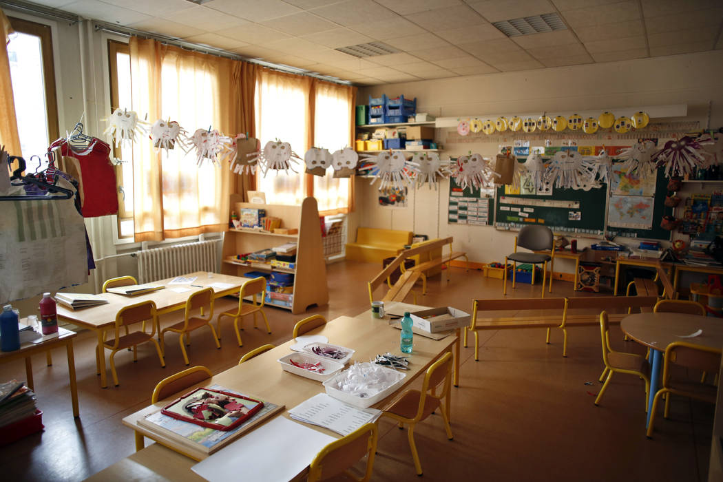 An empty classroom is seen at a closed school in Paris, Monday, March 16, 2020. France plans to ...