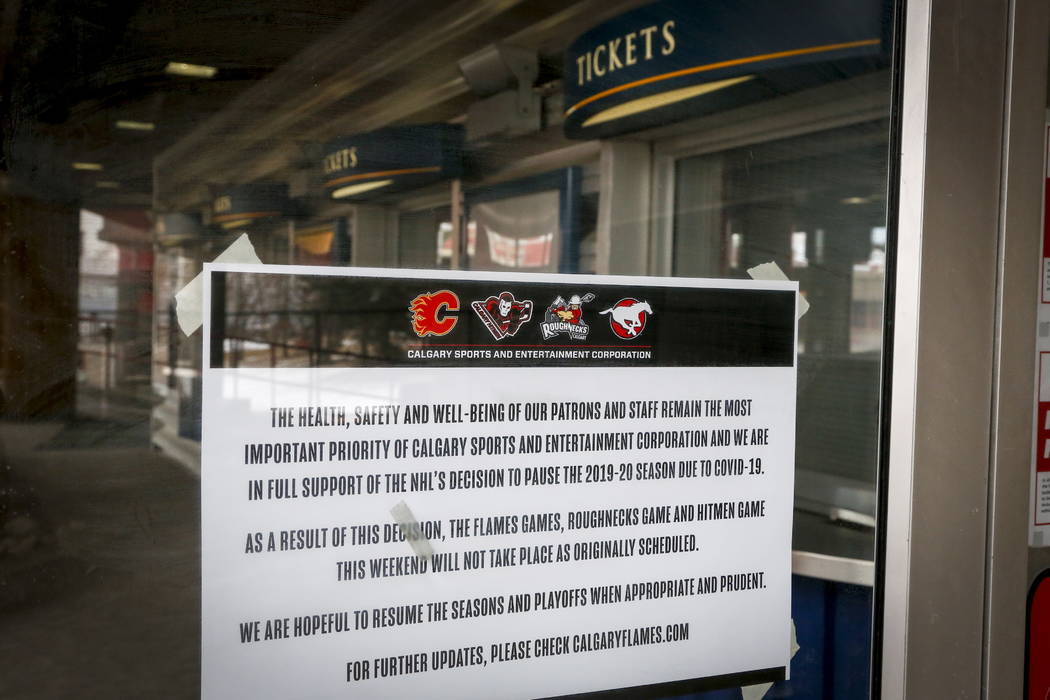 A noticed is affixed to a door of the Saddledome, home of the Calgary Flames, in Calgary, Alber ...