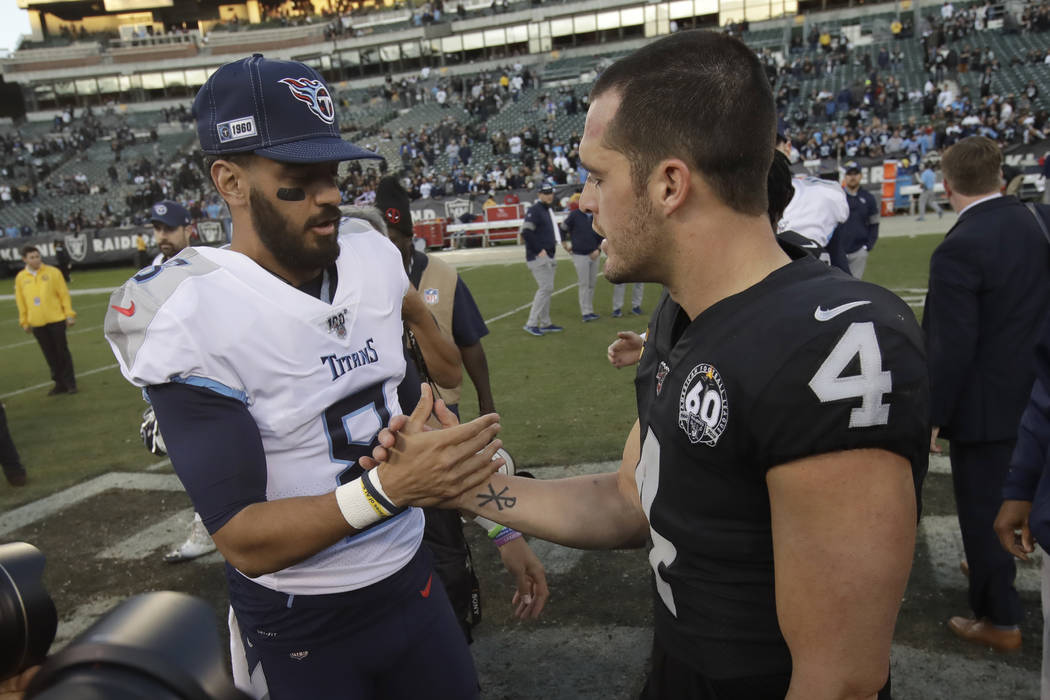 Tennessee Titans quarterback Marcus Mariota, left, greets Oakland Raiders quarterback Derek Car ...