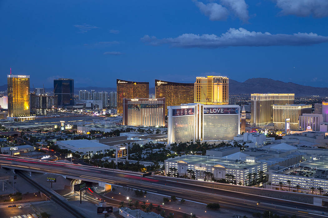 The Las Vegas Strip lights up at dusk as seen from the VooDoo Lounge atop the Rio. (Las Vegas R ...