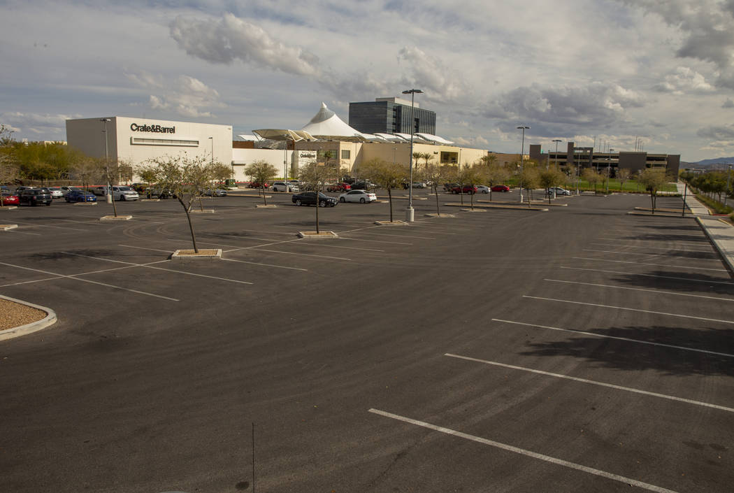 One of the near empty parking lots at Downtown Summerlin which has modified hours and some busi ...