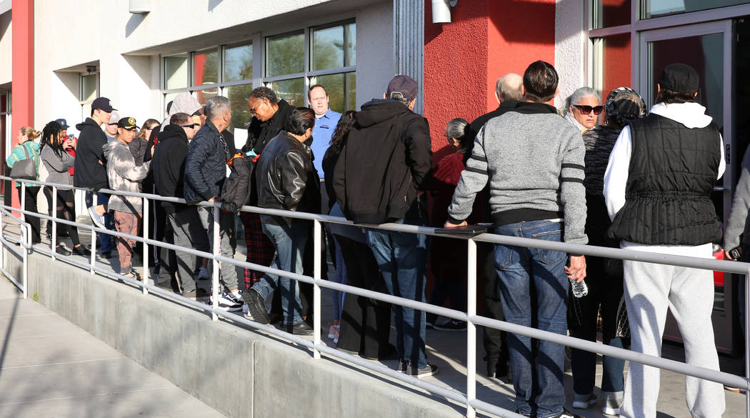 People wait in line at One-Stop Career Center on Monday, March 16, 2020, in Las Vegas. (Bizuaye ...