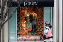 Hold for Swayne Hall Business Photo-A shopper passes the display in the window of a J.Crew stor ...