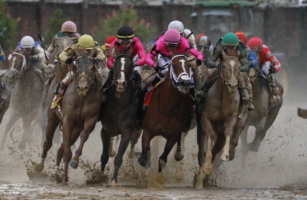 In this May 4, 2019, file photo, Luis Saez riding Maximum Security, second from right, goes aro ...