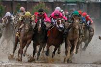 In this May 4, 2019, file photo, Luis Saez riding Maximum Security, second from right, goes aro ...