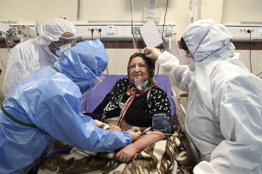 FILE— In this Sunday, March 8, 2020 file photo, medics treat a patient infected with the ...