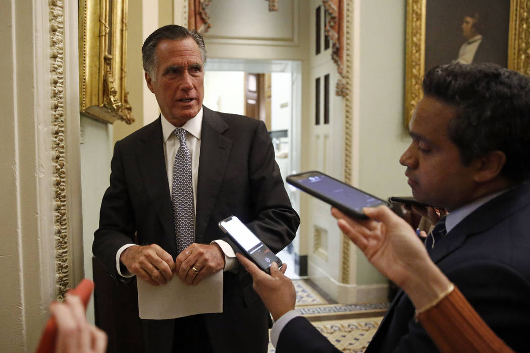 Sen. Mitt Romney, R-Utah, speaks with members of the media as he departs a meeting with Treasur ...