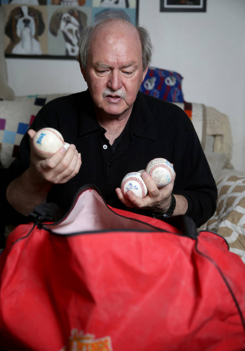 High school umpire Jim Bullock shows collectable baseballs from every league he worked at his L ...