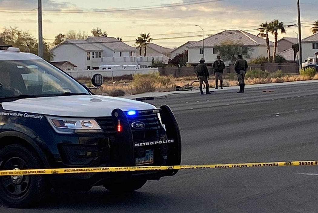 Las Vegas police officers investigate the death of a man found near West Azure Drive and Tenaya ...