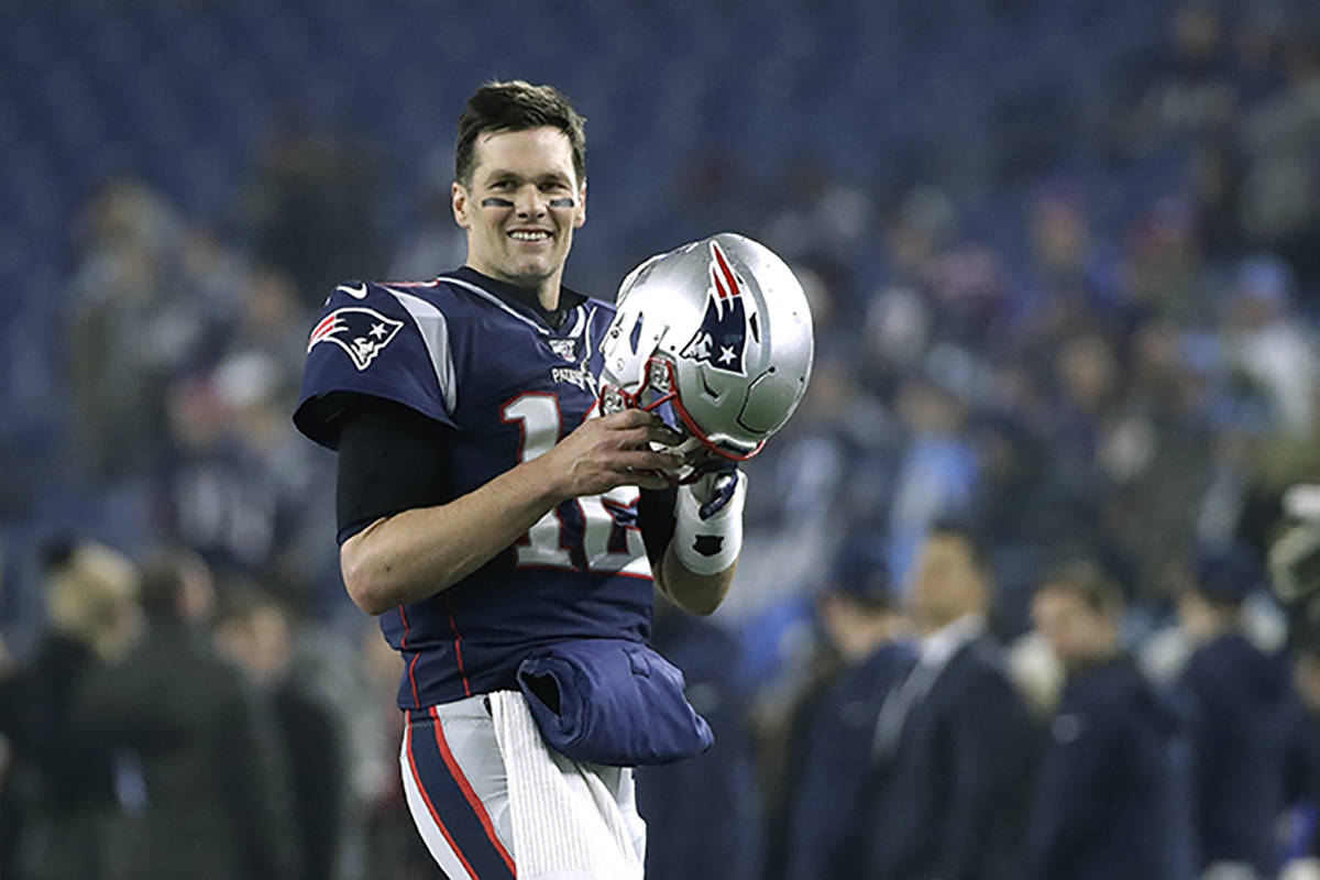 New England Patriots quarterback Tom Brady warms up before an NFL wild-card playoff football ga ...