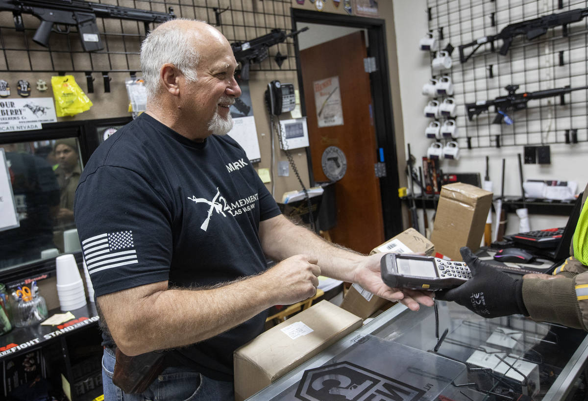 Mark Hames receives a shipment of more gun products at 2nd Amendment Gun Shop on Tuesday, March ...