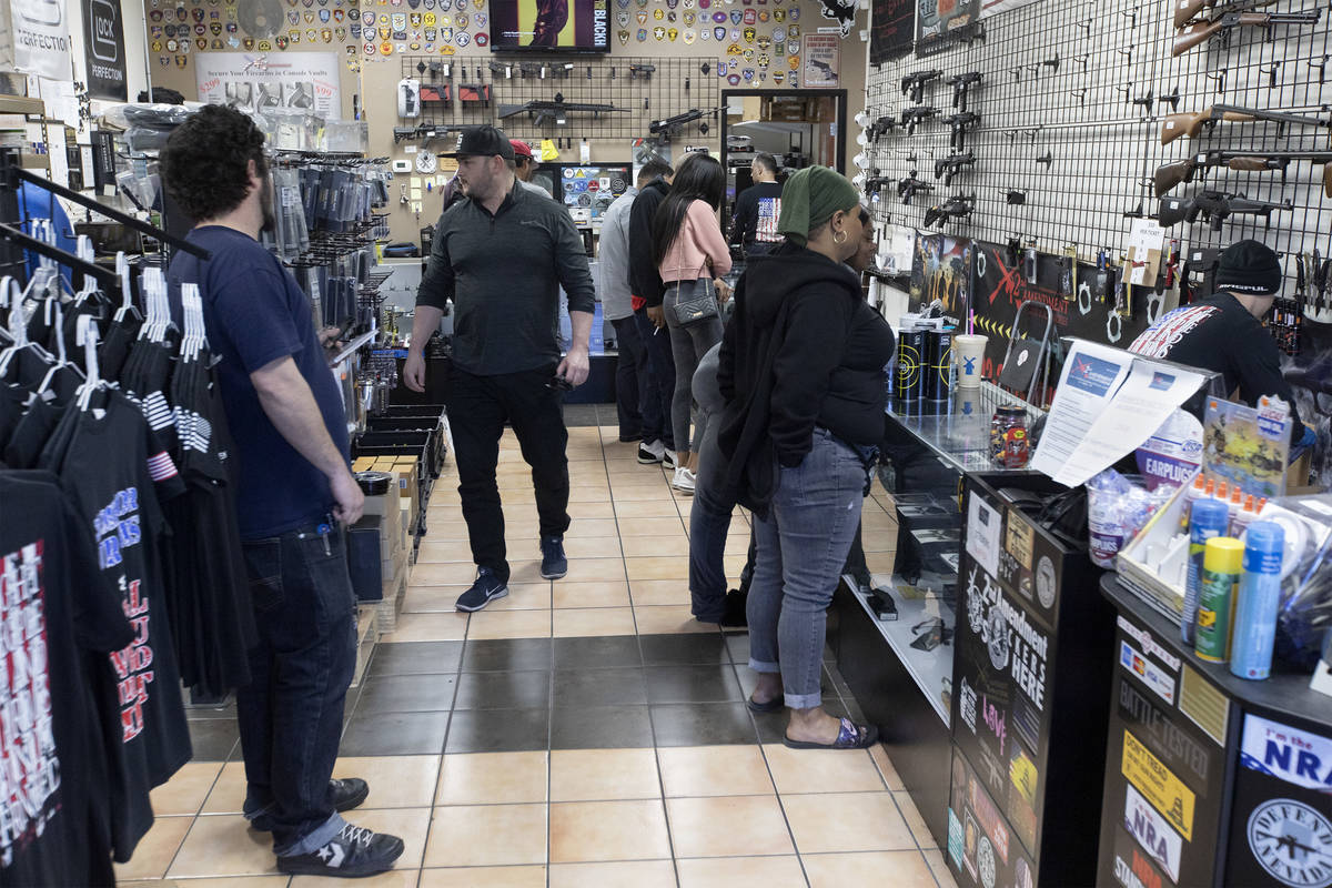 Customers shop at 2nd Amendment Gun Shop on Tuesday, March 17, 2020, in Las Vegas. (Ellen Schmi ...