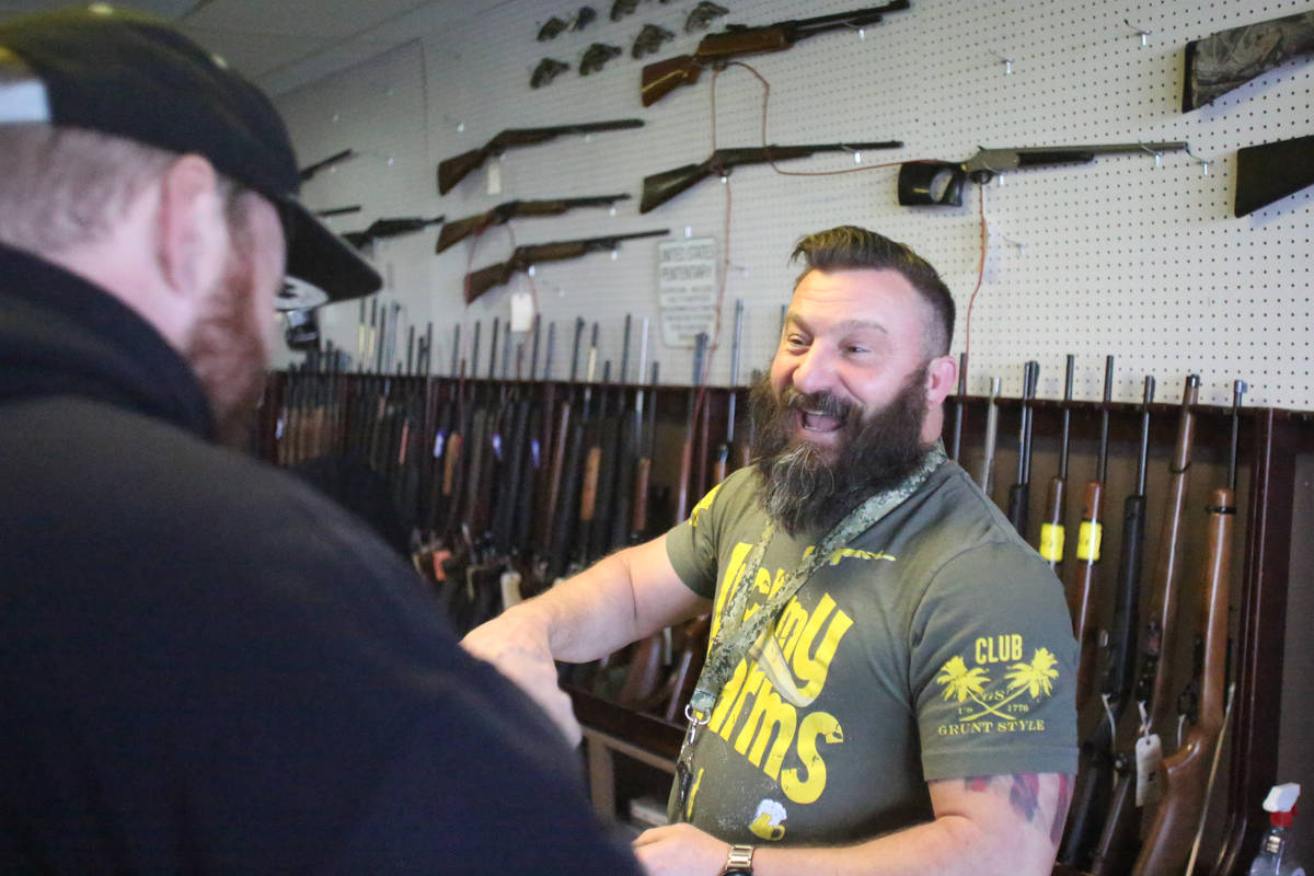 Sales of guns and ammo have been high at Elite Firearms where salesman Joseph Potter assists a ...