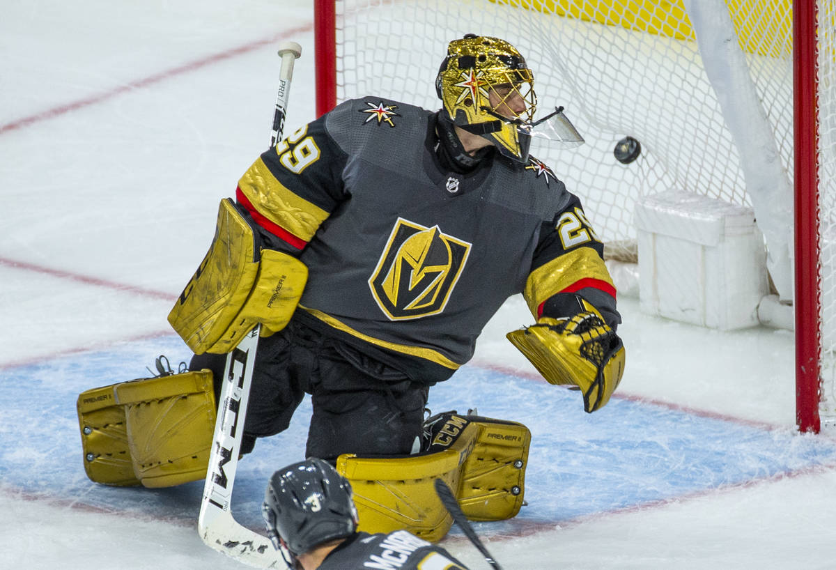 The puck gets past Vegas Golden Knights goaltender Marc-Andre Fleury (29) for the Washington Ca ...
