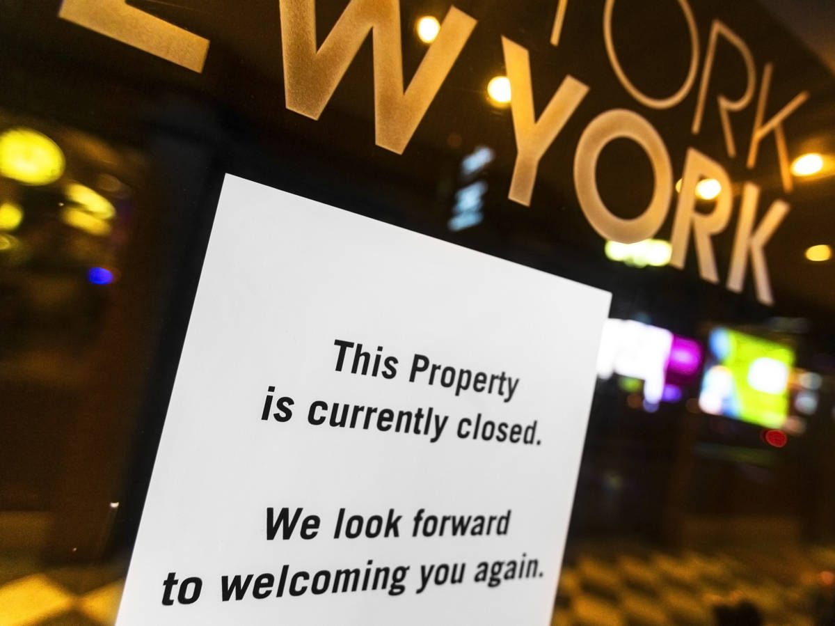 A closed sign is posted on the door of New York-New-York due to concerns related to the spread ...