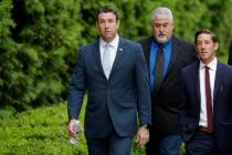 Convicted ex-Rep. Duncan Hunter, left, walks towards a court building for sentencing Tuesday, M ...