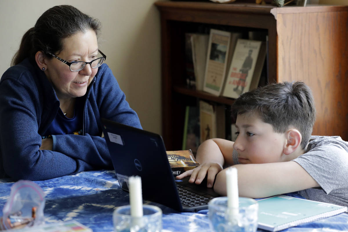 Sarah Marton, para-professional at Niles Township District for Special Education, left, talks w ...