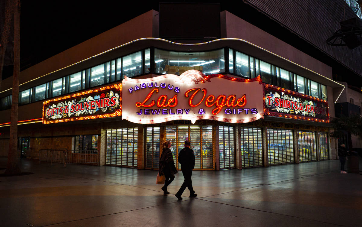 People walk past the closed Fabulous Las Vegas Jewelry & Gifts store at the Fremont Street ...