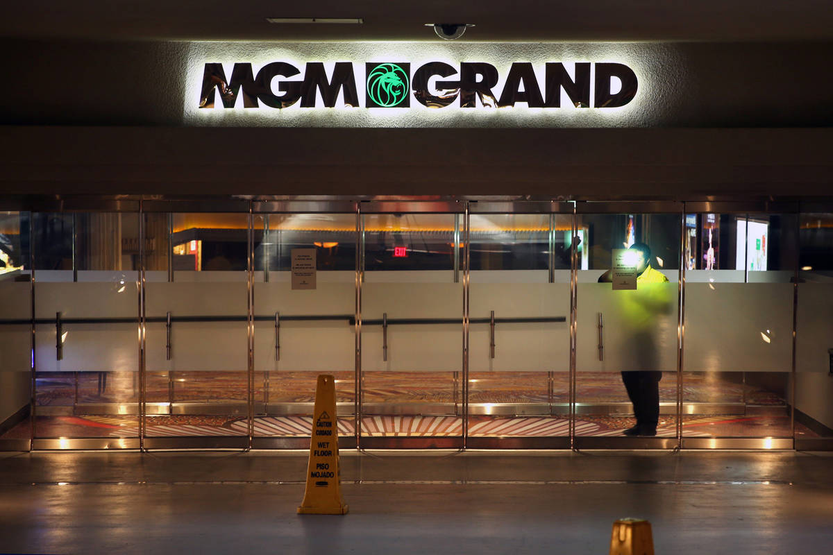 A security guard patrols inside the outer doors of the MGM Grand as non-essential business clos ...