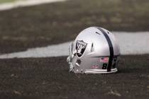 An Oakland Raiders helmet sits on the Oakland-Alameda County Coliseum field before the game aga ...