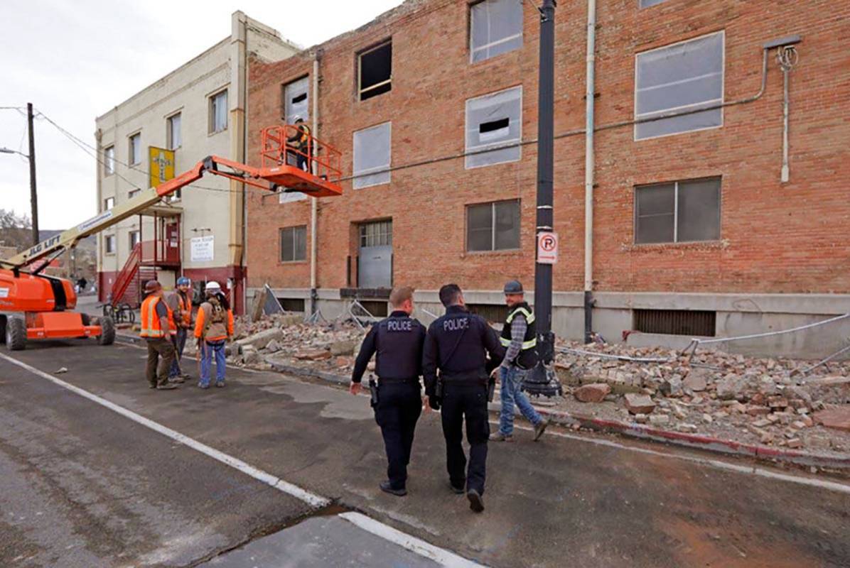 Police officers walk pass rubble after an earthquake Wednesday, March 18, 2020, in Salt Lake Ci ...
