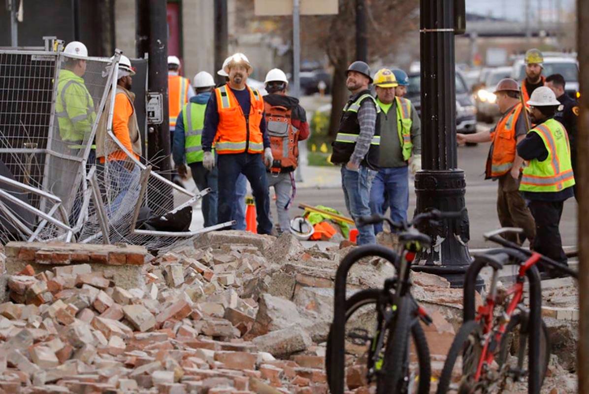 Construction workers looks at the rubble from a building after an earthquake Wednesday, March 1 ...