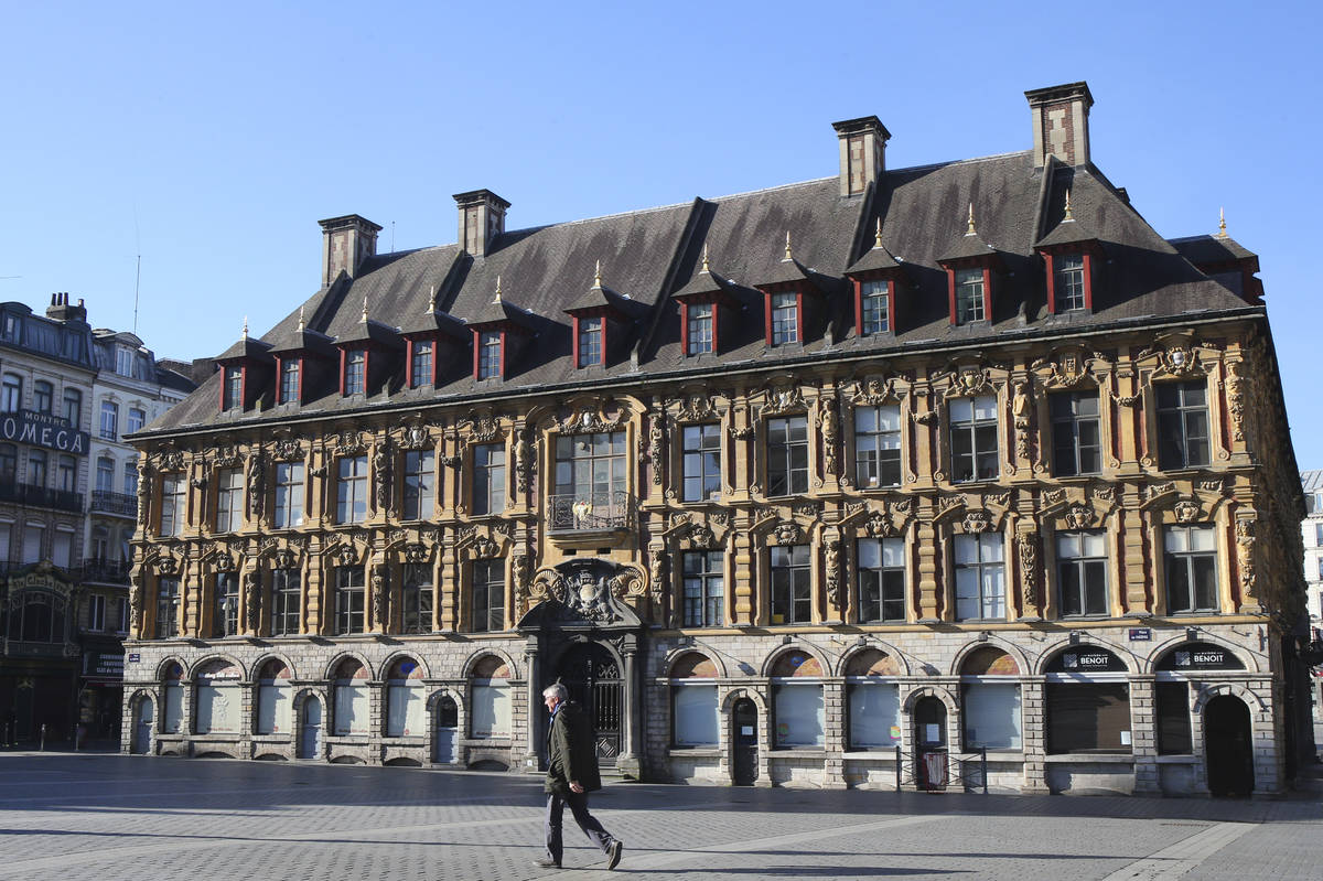 A man walks in a deserted main square in Lille, northern France, Wednesday, March 18, 2020. For ...