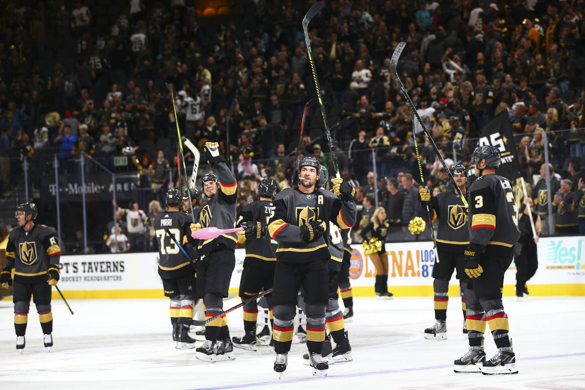 Golden Knights players celebrate their 4-1 victory over the San Jose Sharks in an NHL season-op ...