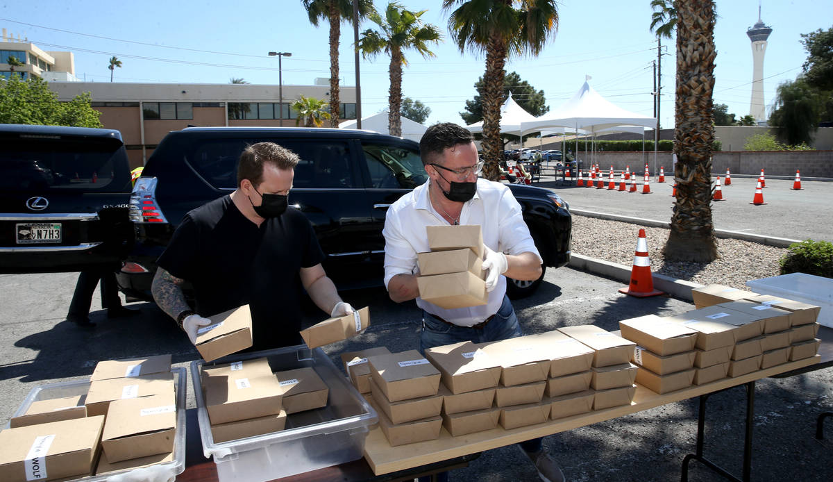 Brian Howard, left, and John Anthony, co-owners of Sparrow + Wolf restaurant, deliver food to p ...