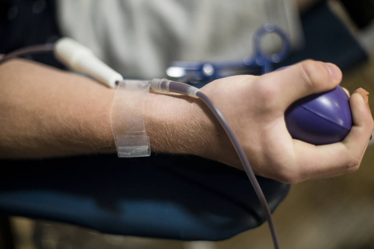 William Buening, 17, gives blood at a blood drive hosted by Vitalant Blood Services at Southern ...