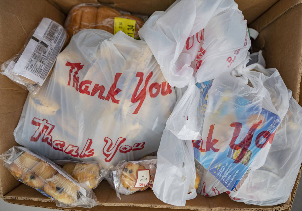 An emergency food box is prepared to be given to the public at Lutheran Social Services of Neva ...