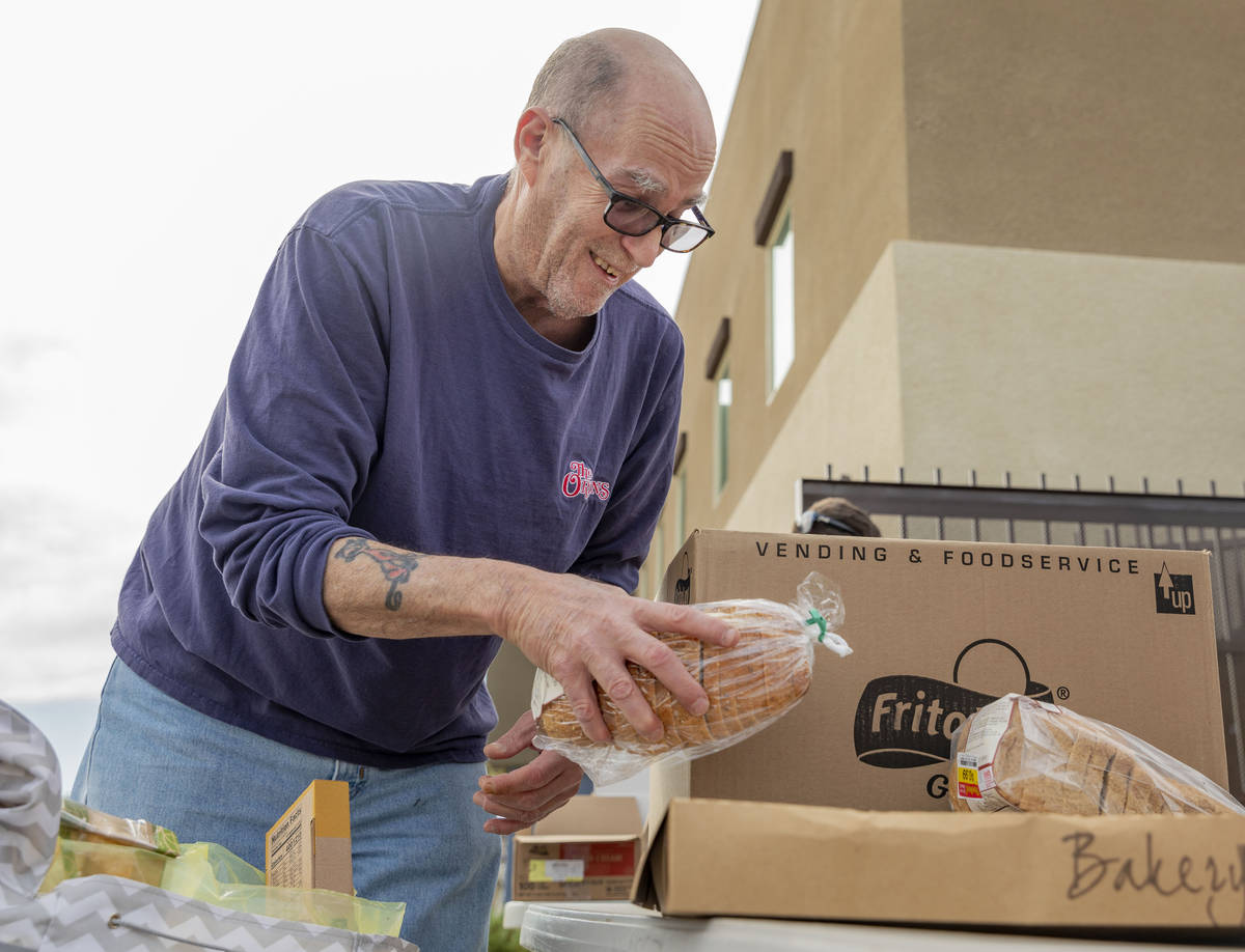 Richard Brint, 63, of Las Vegas collects and emergency food box from Lutheran Social Services o ...
