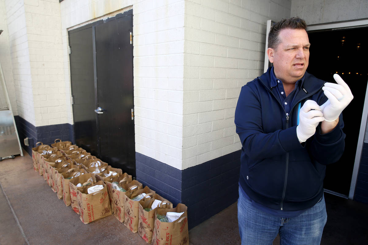 Carson Kitchen owner Cory Harwell prepares to deliver food bags to laid off employees at his La ...