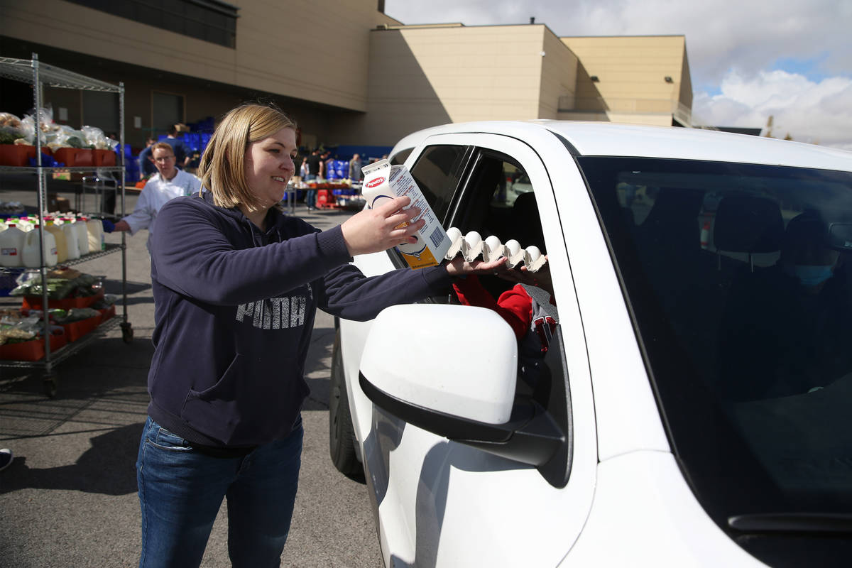 Food and beverage manager Julia Posada hands out food to a team member at the M Resort hotel-ca ...