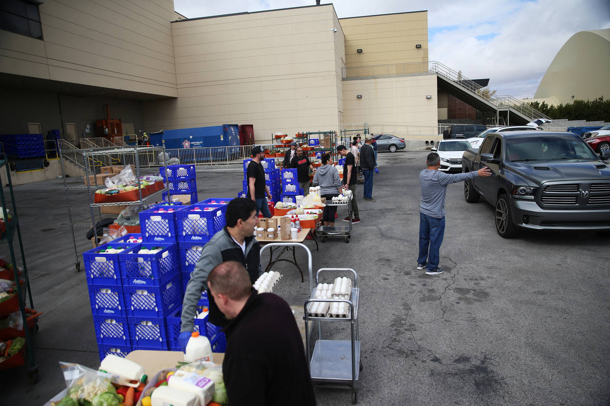 Team members hand out food to co-workers outside of the loading dock at the M Resort hotel-casi ...