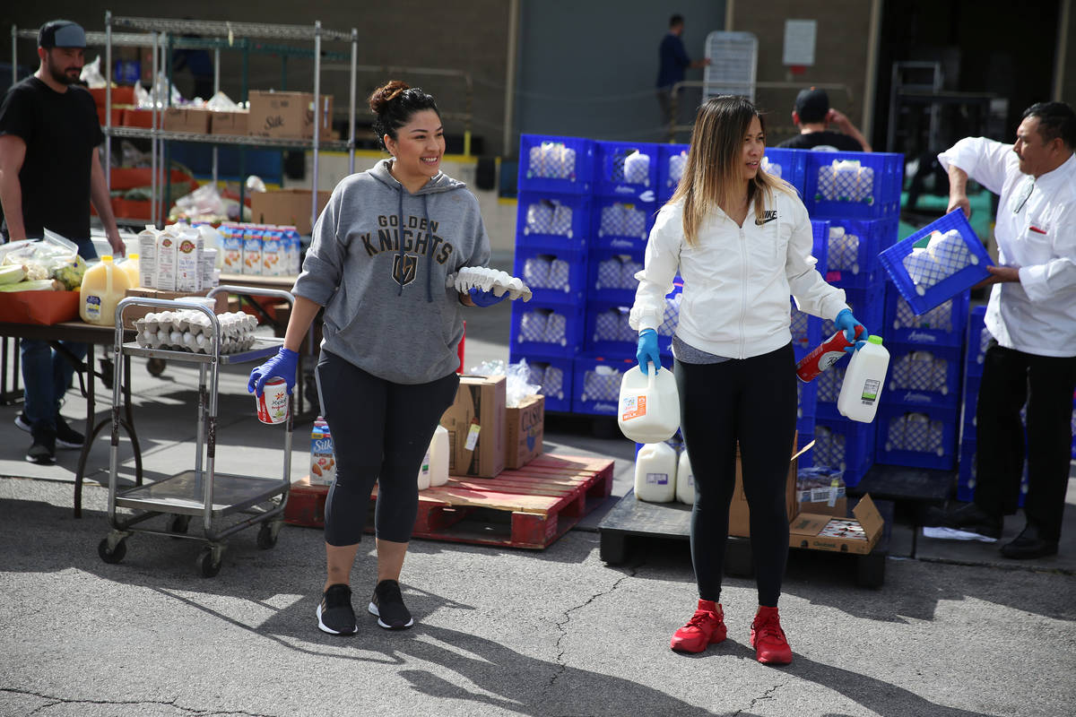 Assistant manager Jenny Leiva, left, and food and beverage manager Rovie Delapaz, wait to hand ...