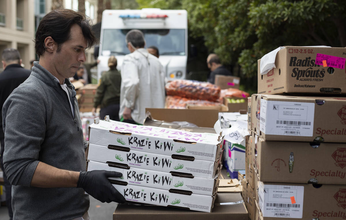 Anthony Amoroso, corporate executive chef for MGM Resorts, unloads kiwi to be donated to the pu ...